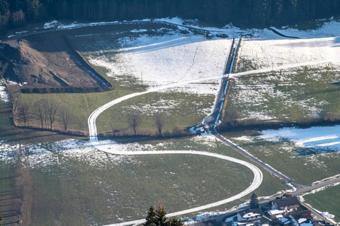 Snow-covered trail between green meadows, Brixental, Tyrol, Austria