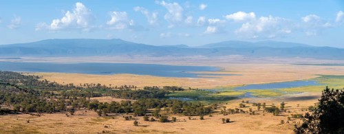 View of savanna landscape and lakes in the Ngorongoro Crater from the crater rim in the evening