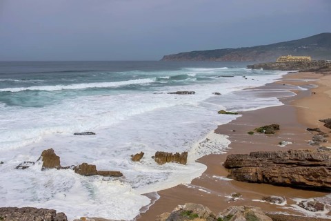 Praia da Cresmina, in the background Fortaleza do Guincho, now a 5-star hotel, Portugal
