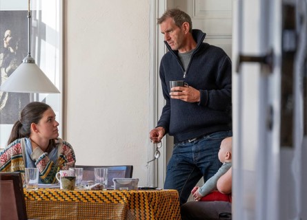 Home office, father and daughter working at the breakfast table, grandchild on the right,