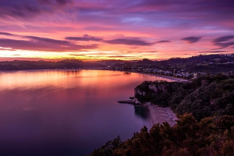 Landscape with sea and sandy beach in New Zealand. View of Lonely Bay and Cooks Beach from