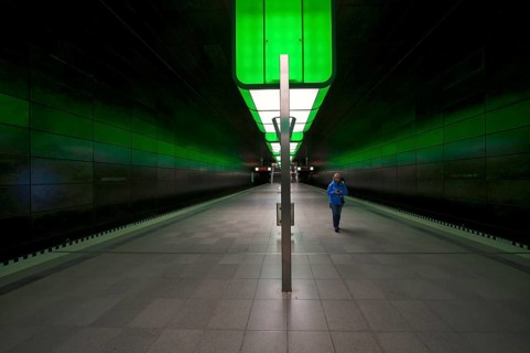 HafenCity University subway station, illuminated in color, green, travelers, platform, stop, train