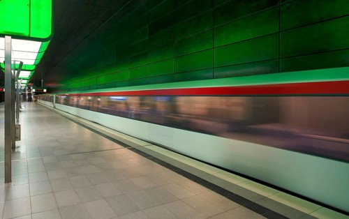 HafenCity University underground station, illuminated in color, green, underground train, movement