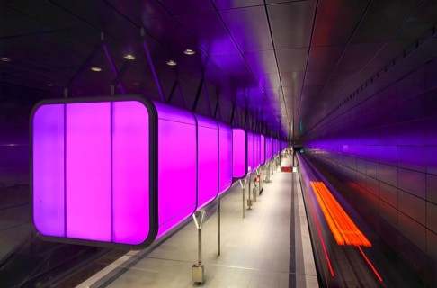 HafenCity University underground station, illuminated in color, magenta, underground train, motion