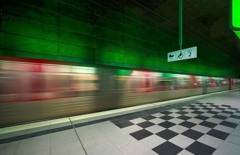 HafenCity University underground station, illuminated in color, green, underground train, movement