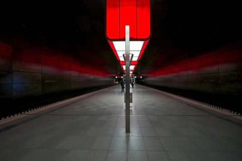 HafenCity University subway station, illuminated in color, red, travelers, platform, stop, train