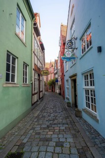 Colourful houses with shops and half-timbered houses in a small alley, picturesque district with