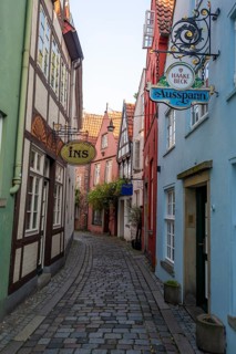 Colourful houses with shops and restaurants, half-timbered houses in a small alley, picturesque
