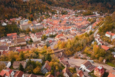 Bird's eye view of a picturesque urban landscape surrounded by forest and autumn colors, Calw,