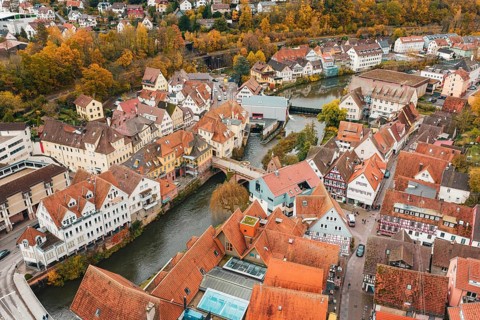 Historic old town with half-timbered houses and river views, surrounded by autumn trees, Calw,