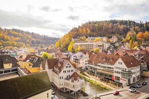 View of the city with autumn trees and hills in the background, Calw, Black Forest, Germany