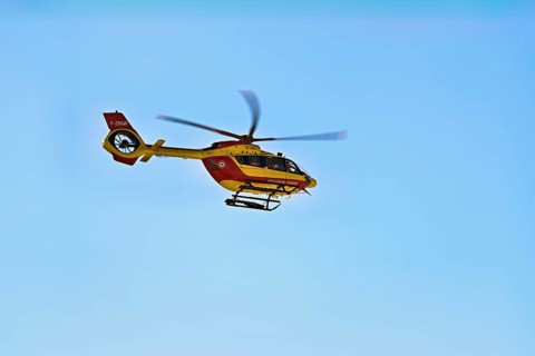 Helicopter flying against a blue sky, alpine rescue, mountain rescue, Chamonix, Haute-Savoie,