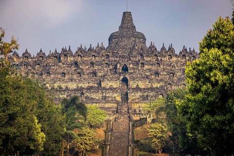 The impressive Borobudur Temple nestled in green surroundings in Indonesia