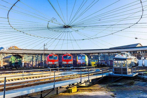 Turntable and overhead line spider, behind it modern locomotives of the Austrian Federal Railways,