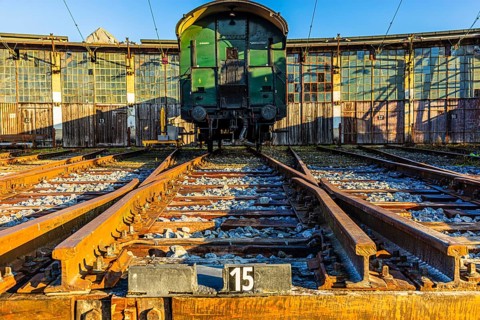 Historic railroad car parked in front of the old engine shed, Augsburg railway park, administrative