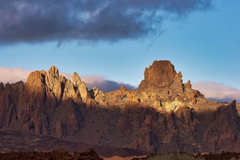 Dramatically illuminated rocks under a partly cloudy sky, UNESCO World Heritage Site, Teide