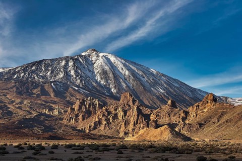 Snow-capped Teide, large mountain with illuminated shadows and deep blue sky, UNESCO World Heritage