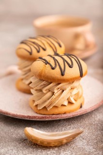 Caramel Cream Cakes on brown concrete background, cup of coffee, side view, close up, selective