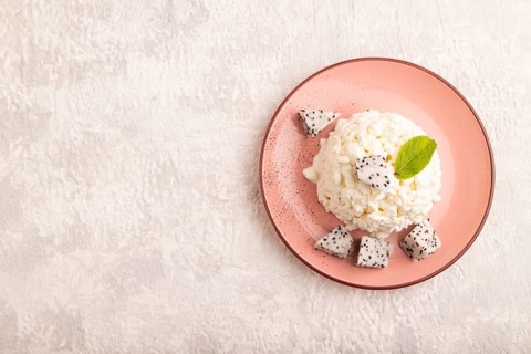 White ?ottage cheese, Curd, with Pithaya on gray concrete background, top view, flat lay, copy
