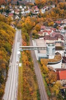View of railroad, tower and municipal buildings surrounded by autumn colors, Hermann Hessebahn, ZOB