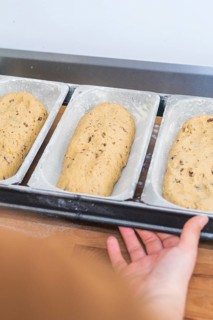 Three loaves of bread dough on a tray, prepared for baking, Christmas baking, Haselstaller Hof,