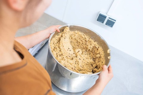 Person holding large bowl of dough in kitchen, preparing for baking, Christmas baking, Haselstaller