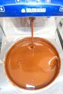 Close-up of liquid chocolate flowing from a machine, Christmas baking, Haselstaller Hof, Wildberg,
