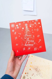 Red advent calendar for chocolate lovers with printed snowflakes, Christmas baking, Haselstaller