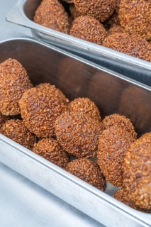 Brown chocolate chocolates with ground hazelnuts served in a metal container, Christmas baking,