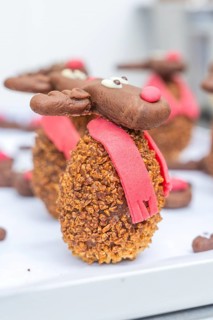A detailed reindeer cookie with red scarf and nose taken up close, Christmas baking, Haselstaller
