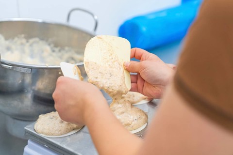 Two hands working with a dough and a silicone spatula on a kitchen table, Christmas baking,