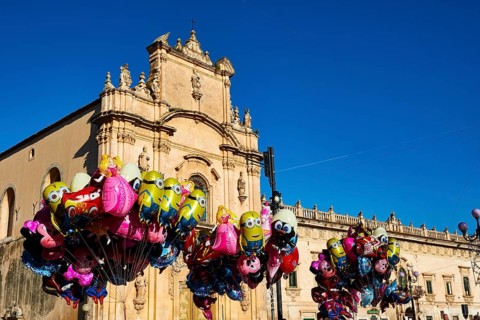 Scigli, Easter Sunday, glowing balloons floating in front of a church, standing out against the