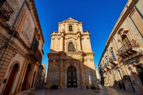Scigli, beautiful baroque church surrounded by historic buildings in clear weather, Baroque towns