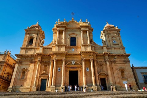 Noto, large baroque church with magnificent façade, stairs leading to the entrance, Baroque towns