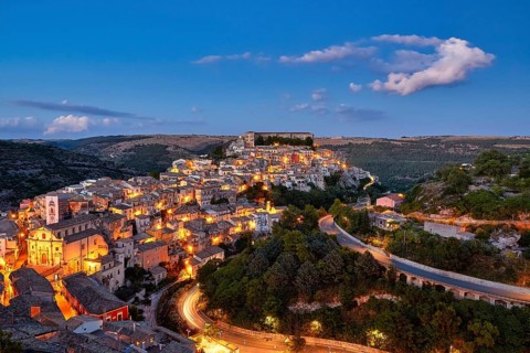 Ragusa, panoramic view of an illuminated city on a hill at night, Baroque towns of Sicily, Baroque