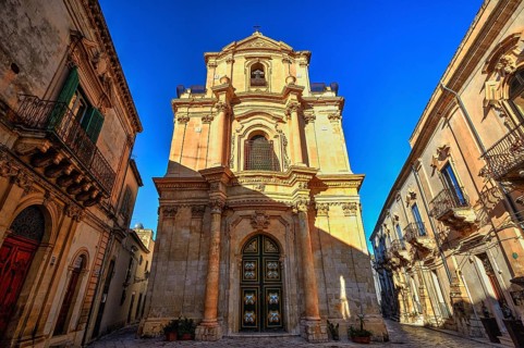 Scigli, magnificent baroque church under clear blue sky, typical of historical architecture,