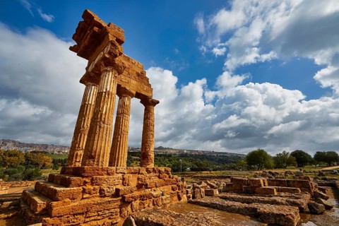 Temple of Dioscuren, ancient temple ruins on a hill under cloudy sky, Valley of the Temples, Valle