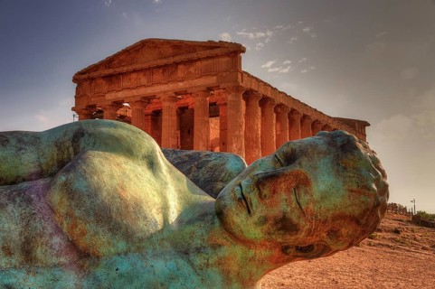 Bronze statue of fallen Icarus, Temple of Concordia, bronze statue in front of an ancient temple in