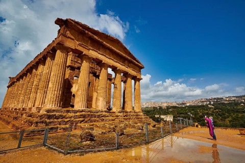Temple of Concordia, large ancient temple with Doric columns and a person in the foreground, Valley