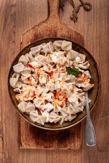 The dish features a generous serving of Turkish dumplings topped with velvety yogurt and a drizzle