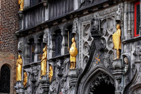 Richly decorated façade and entrance portal with golden figures to the St. Ivo Chapel at the