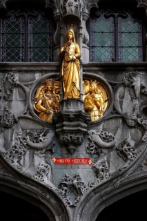 Golden figures on the richly decorated façade of the St. Ivo Chapel at the Basilica of the Holy