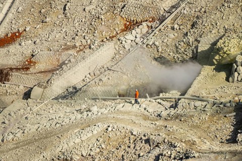 Workers among steaming fumaroles in the Owakudani geothermal area at Komagatake volcano, Hakone,