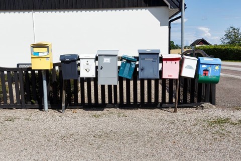 Many different mailboxes on a fence, Ystad, Sweden