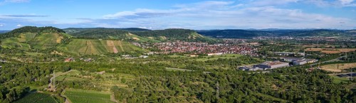 Rural area with a town surrounded by fields and rolling hills under a blue sky, Korb im Remstal