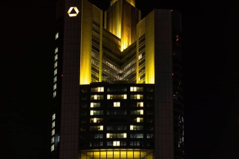 Lights inside the offices project a glowing yellow heart onto the façade of the Commerbank Tower in