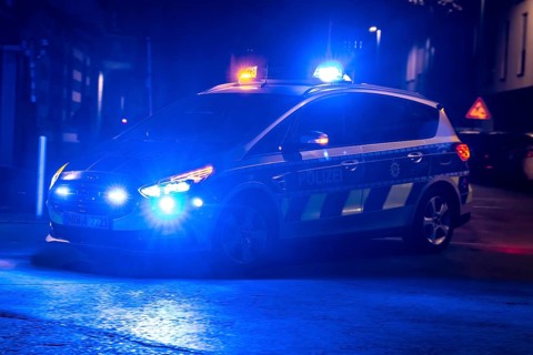 Police patrol car deployed with flashing lights, Essen, North Rhine-Westphalia, Germany