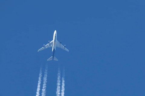 Boeing 747 jumbo jet cargo aircraft of Atlas air airlines flying in a blue sky with contrails or