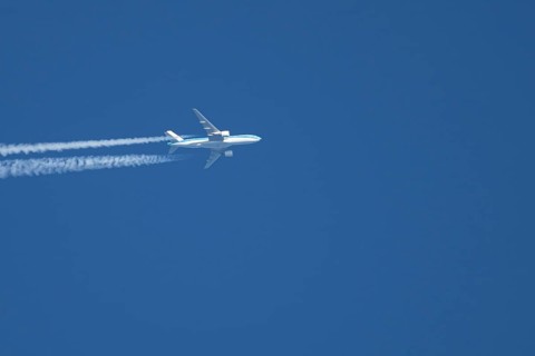 Airbus jet passenger aircraft of Royal Dutch KLM airlines flying in a blue sky with contrails or