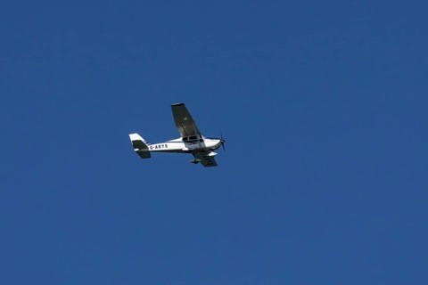 Cessna 172C Skyhawk aircraft flying in a blue sky, England, United Kingdom